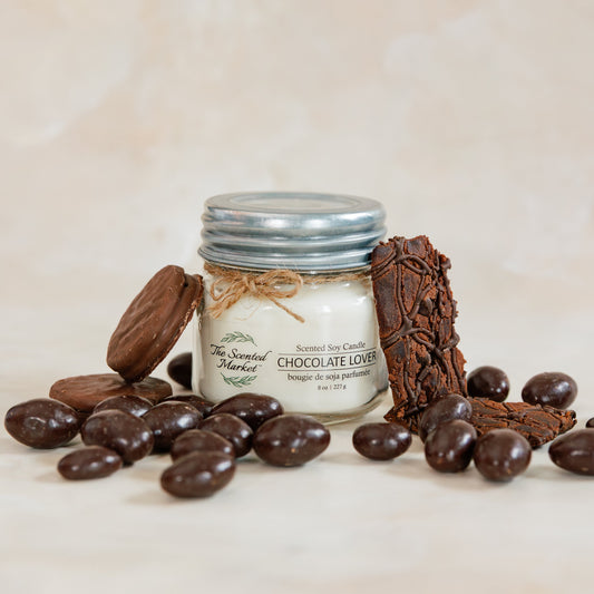 Jar of chocolate truffles with chocolate pieces on a light background