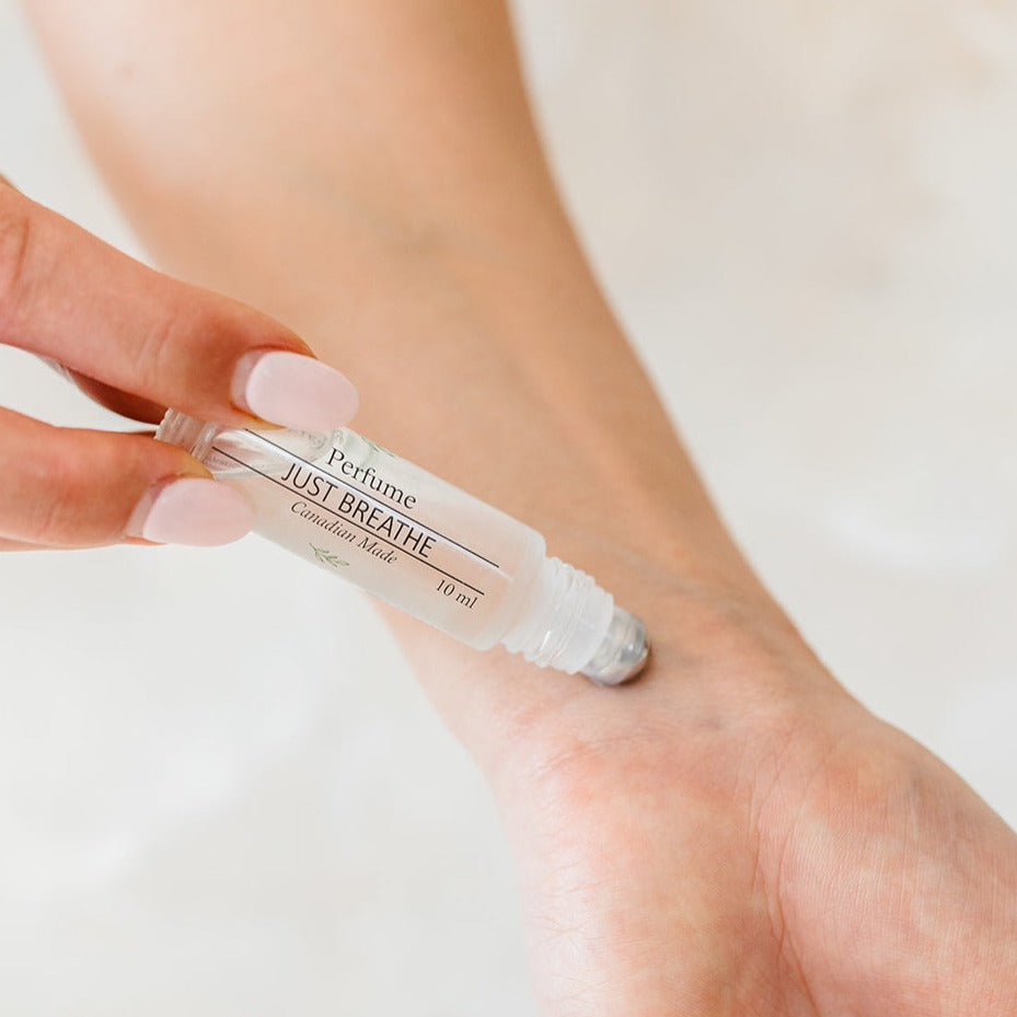Model applying Just Breathe roller ball perfume on wrist